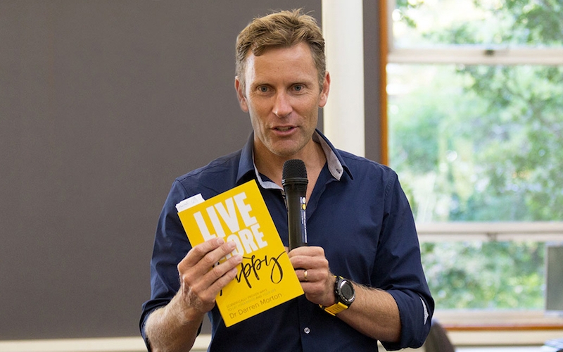 Dr Darren Morton Holding Live More Happy Book