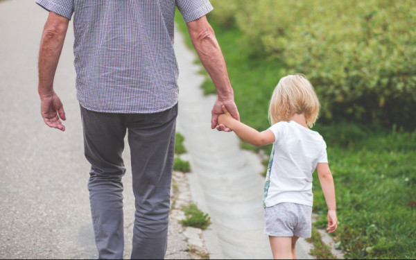 father and young daughter holding hands