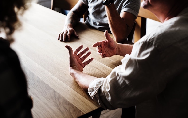 man sharing with group of people