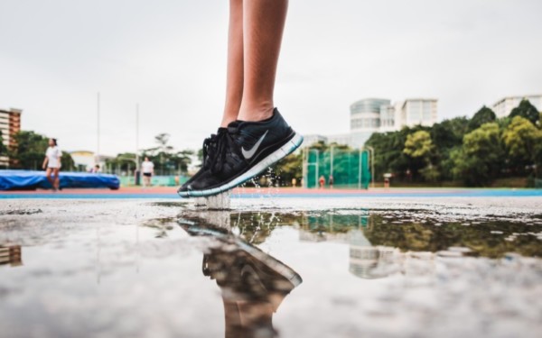 person jumping in a puddle