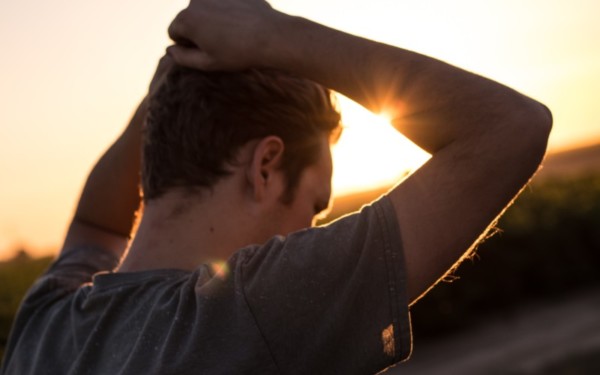 man pondering outside