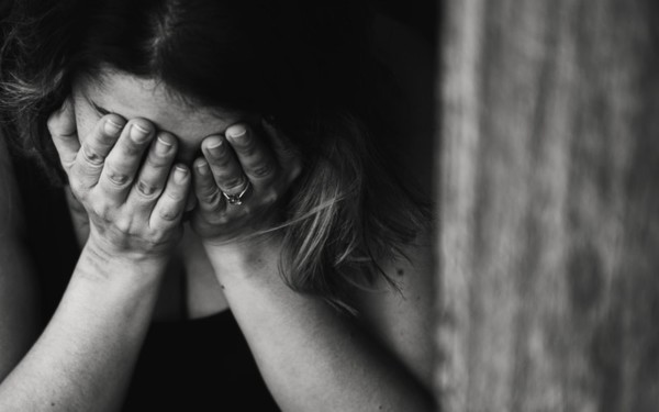 Black and white of person hands on face