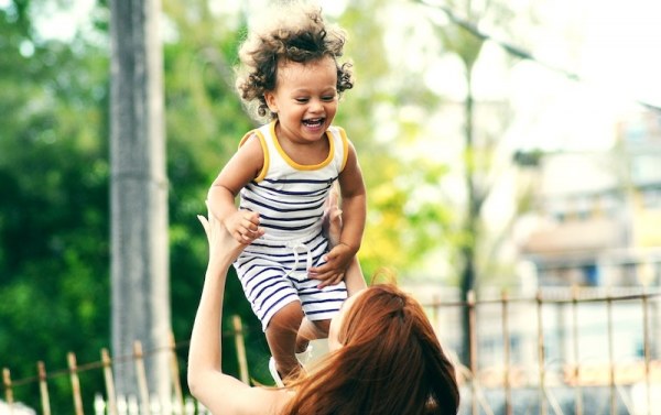 Parent playing with happy child